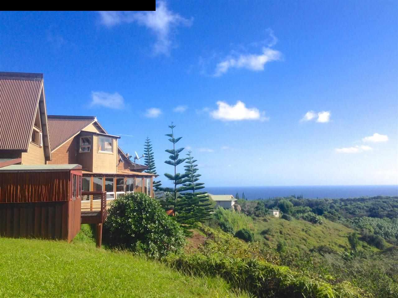 51 South Honokala Road Haiku, HI 96708 - Photo 1 of 28 a front view of a house with a yard