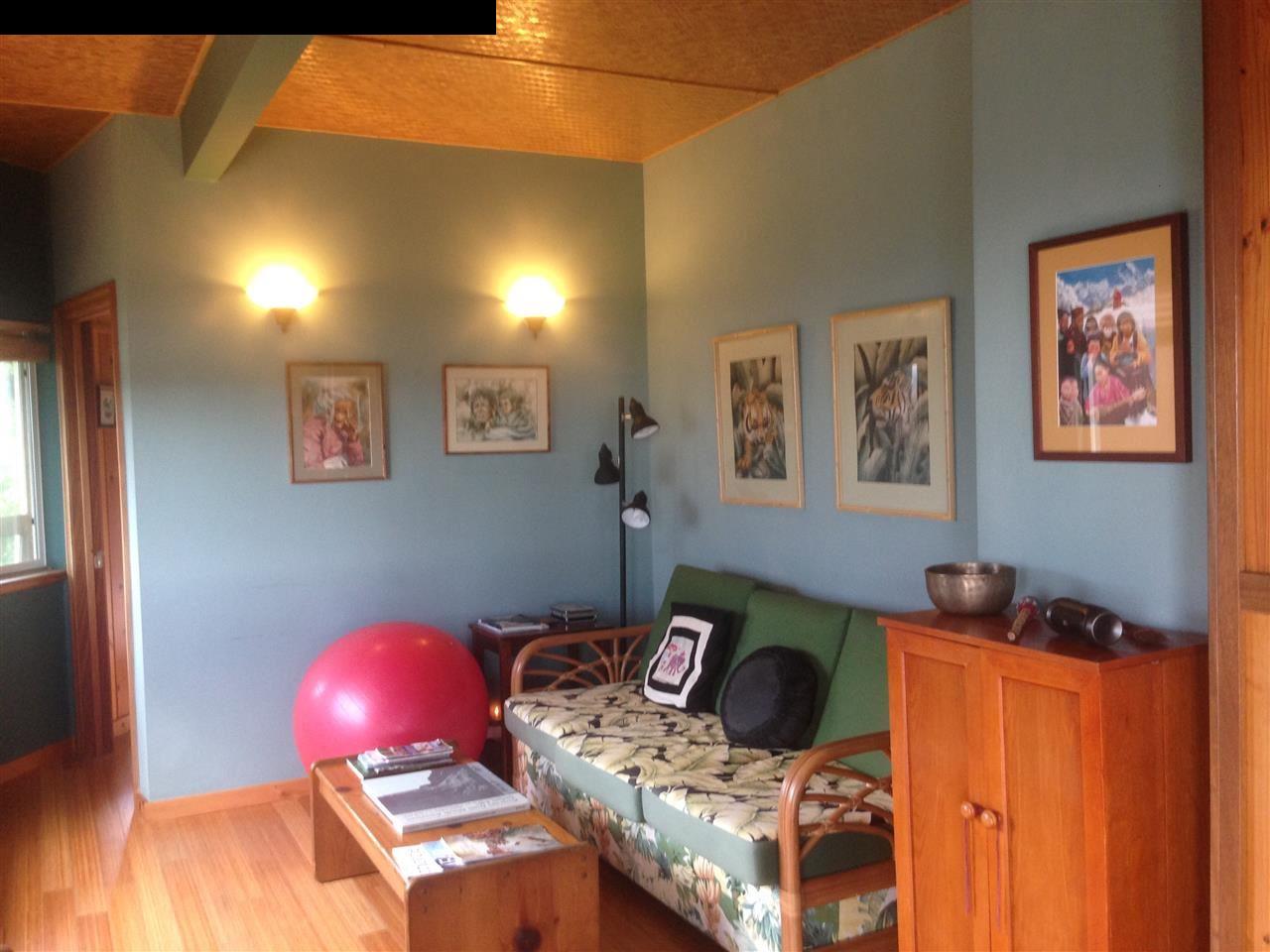 51 South Honokala Road Haiku, HI 96708 - Photo 19 of 28 a bedroom with a bed and wooden floor