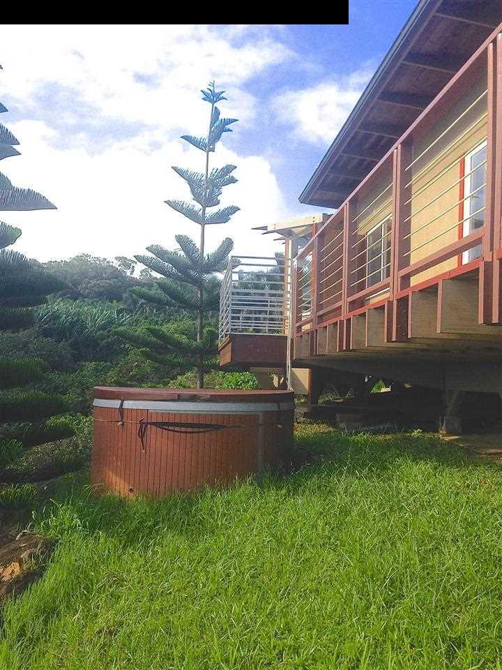 51 South Honokala Road Haiku, HI 96708 - Photo 7 of 28 a view of a house with a yard and a garden