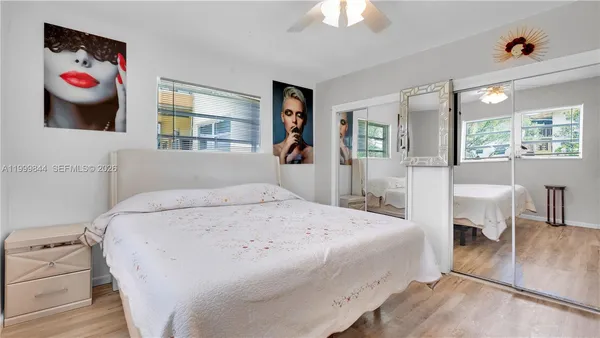 a spacious bedroom with a bed and dresser