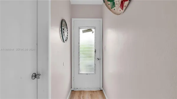 a view of front door with a mirror