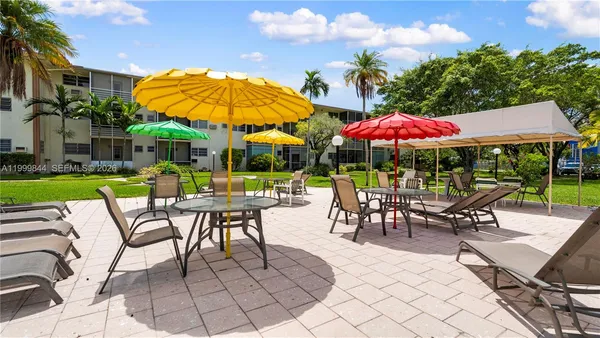 an outdoor space with furniture and umbrella
