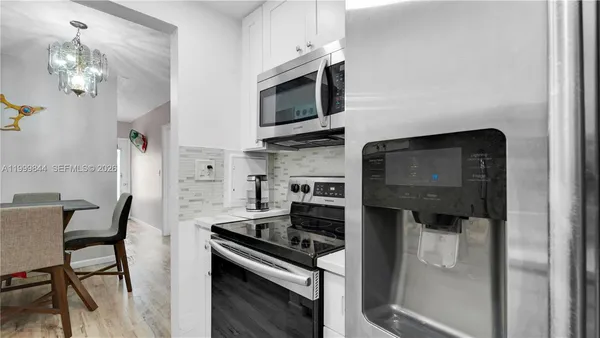 a kitchen with stainless steel appliances a stove a microwave and a refrigerator