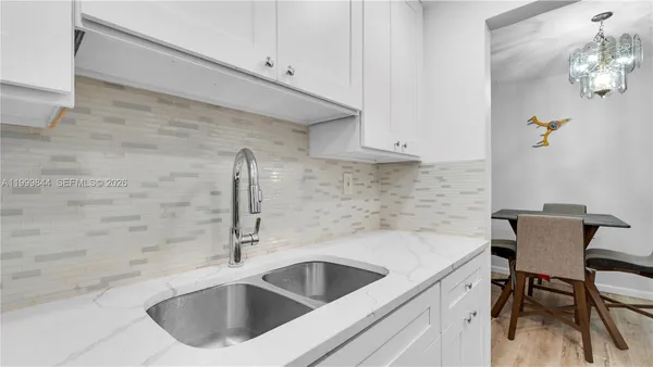 a kitchen with a sink and cabinets