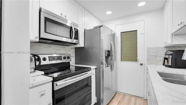 a kitchen with a stove and a microwave