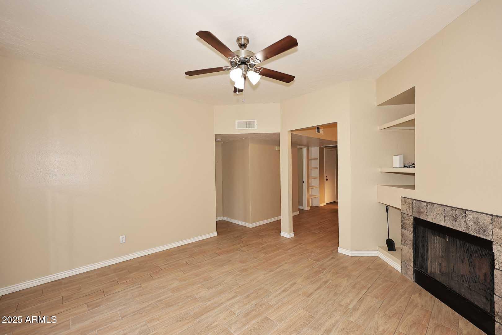 1126 West Elliot Road, Unit 1040 Chandler, AZ 85224 - Photo 11 of 25 a view of an empty room with closet and a ceiling fan