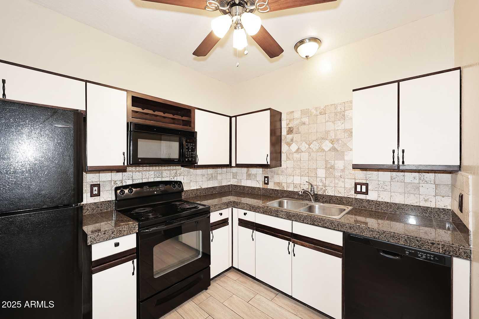 1126 West Elliot Road, Unit 1040 Chandler, AZ 85224 - Photo 14 of 25 a kitchen with stainless steel appliances a sink stove and cabinets