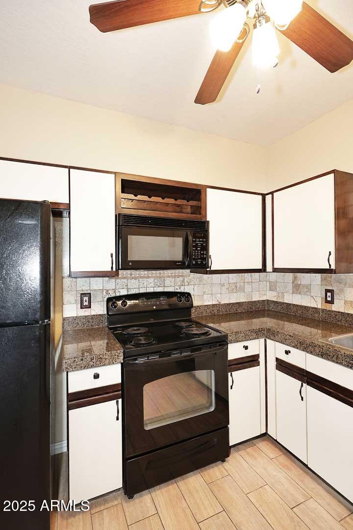 1126 West Elliot Road, Unit 1040 Chandler, AZ 85224 - Photo 15 of 25 a kitchen with a stove and a microwave