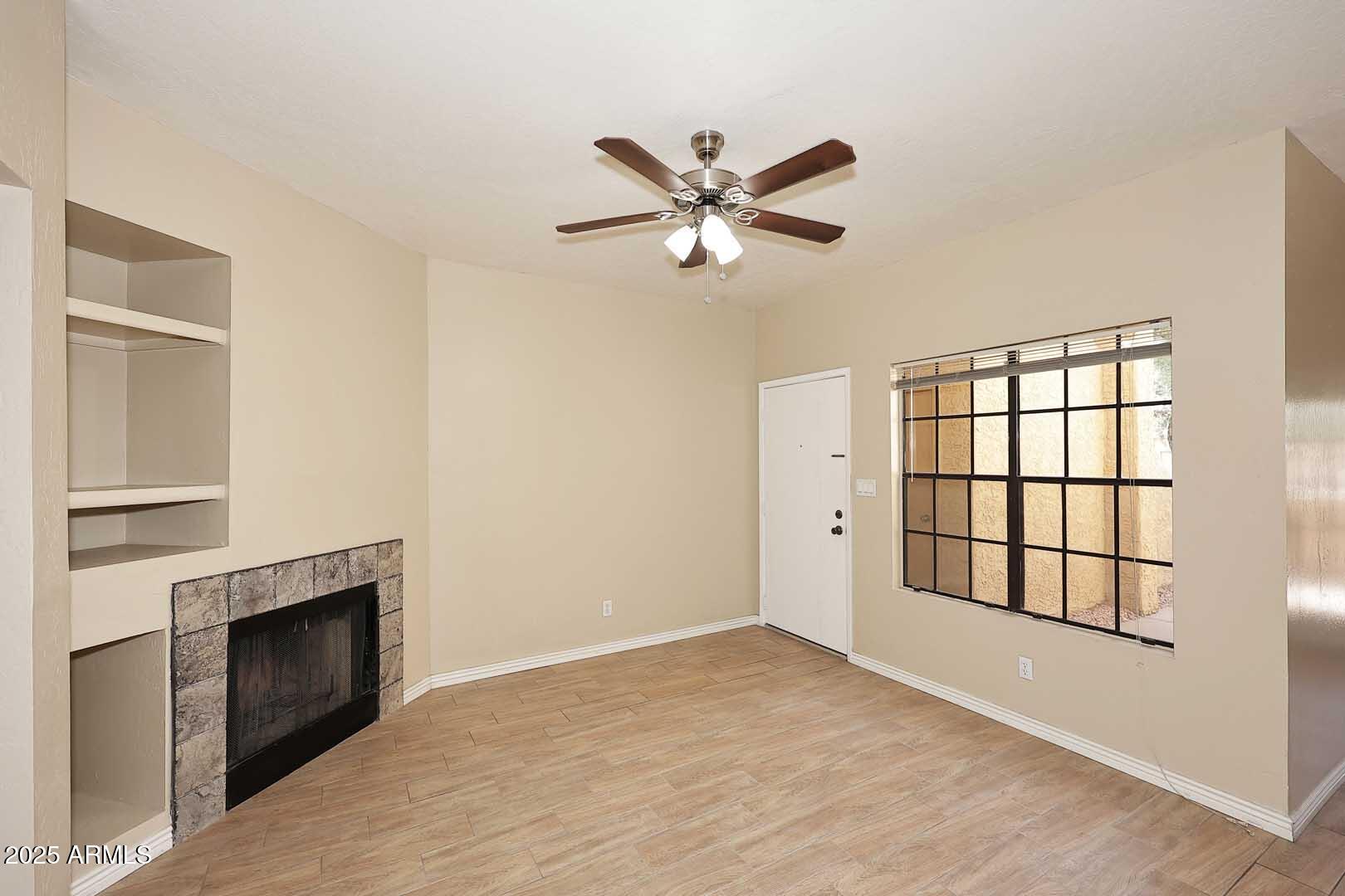 1126 West Elliot Road, Unit 1040 Chandler, AZ 85224 - Photo 10 of 25 a view of an empty room with a fireplace and a window
