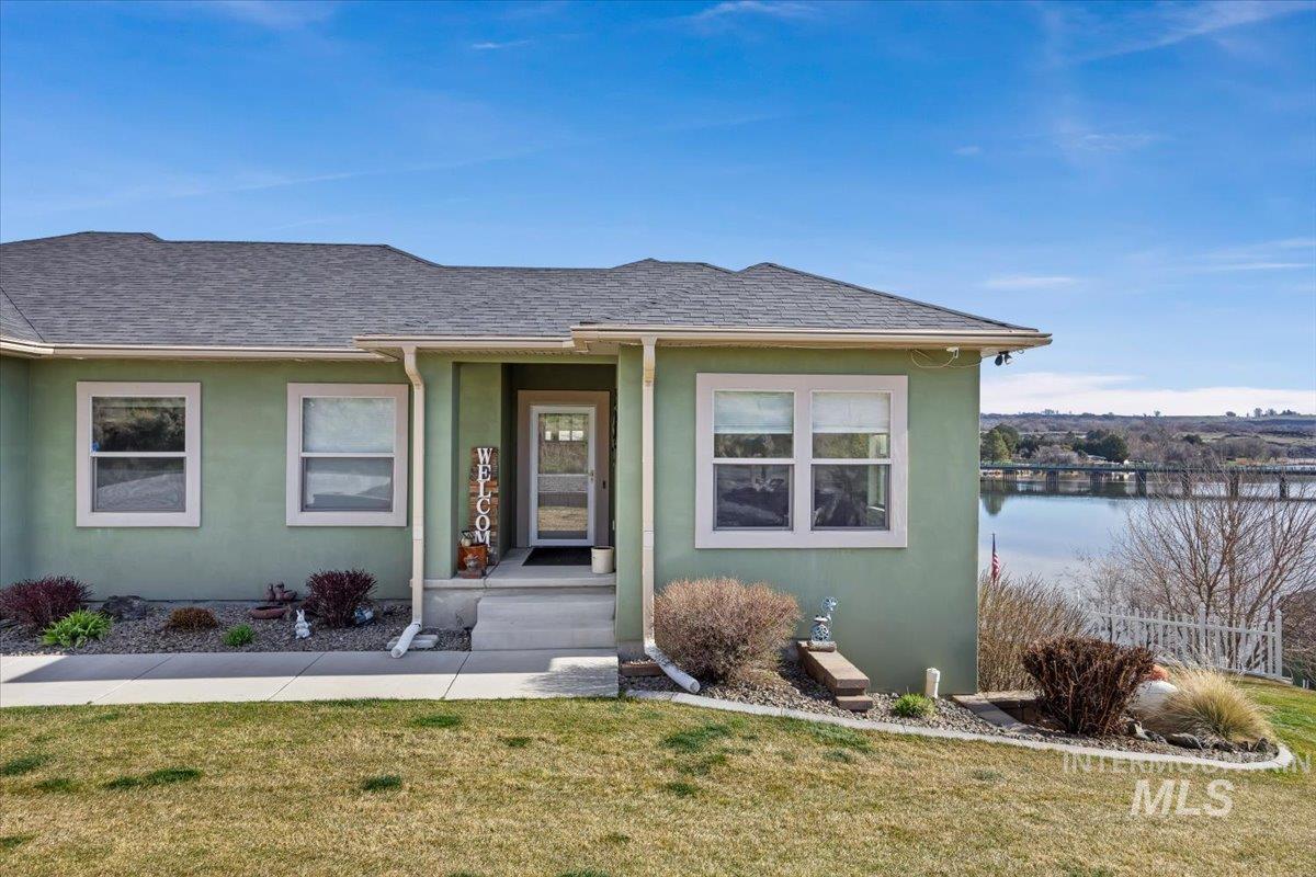 40 Bell Rapids Road Hagerman, ID 83332 - Photo 2 of 50 Property entrance with stucco siding, a yard, a shingled roof, and a porch