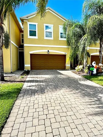 a front view of a house with a yard and a garage