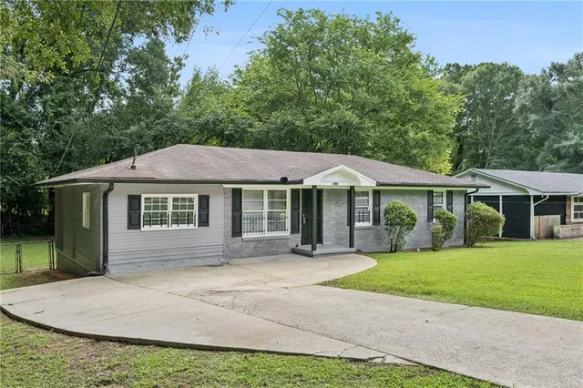 a front view of a house with a garden