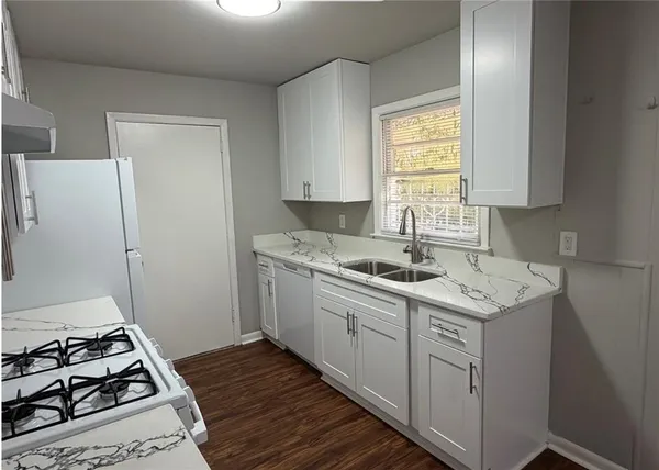a kitchen with a sink cabinets and window