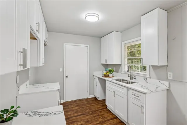 a kitchen with a sink cabinets and window