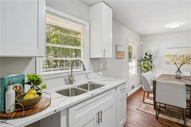 a kitchen with a sink cabinets and window