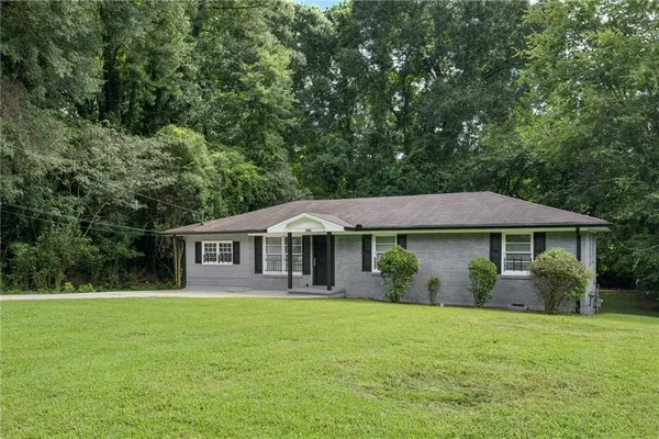 a front view of a house with a garden
