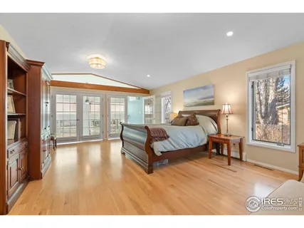 a spacious bedroom with a large bed and a large window