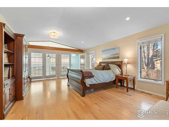 a spacious bedroom with a large bed and a large window