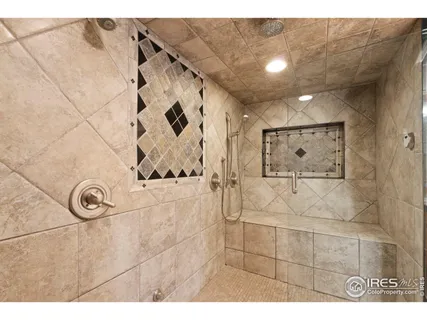 a bathroom with a granite countertop sink mirror and shower