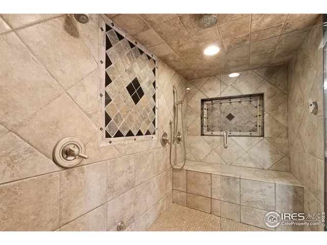 a bathroom with a granite countertop sink mirror and shower