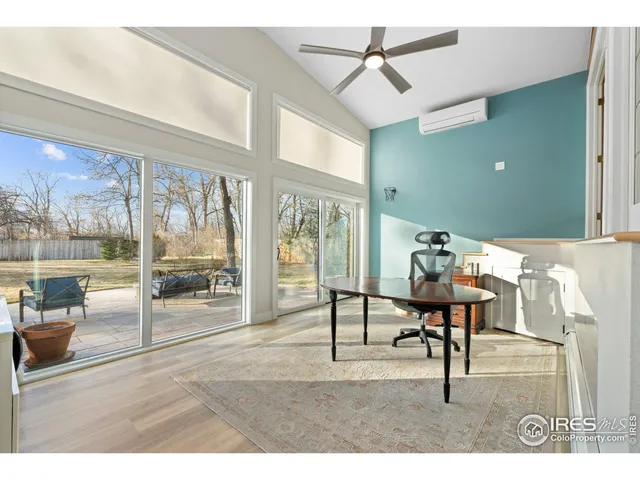 a living room with stainless steel appliances furniture and kitchen view