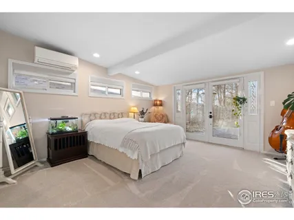 a bedroom with a large bed and a large mirror