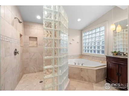 a spacious bedroom with a bed and painting on the wall