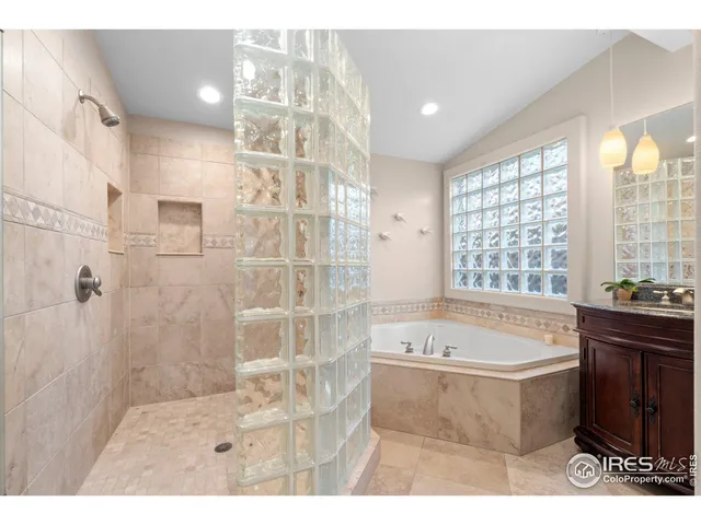 a spacious bedroom with a bed and painting on the wall