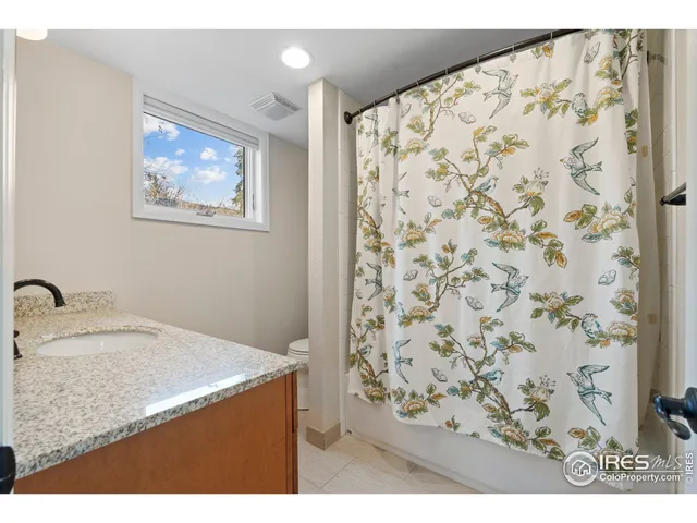 a bedroom with a bed and a potted plant