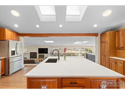 a large kitchen with stainless steel appliances a large counter top