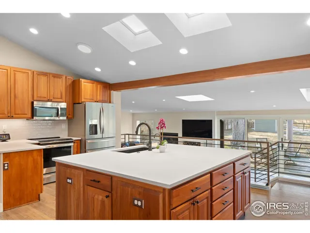 a kitchen with a sink a center island cabinets and appliances
