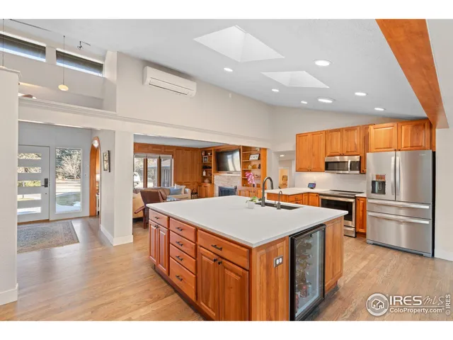 a kitchen with stainless steel appliances granite countertop a sink a stove and a refrigerator