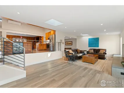 a living room with furniture and large windows