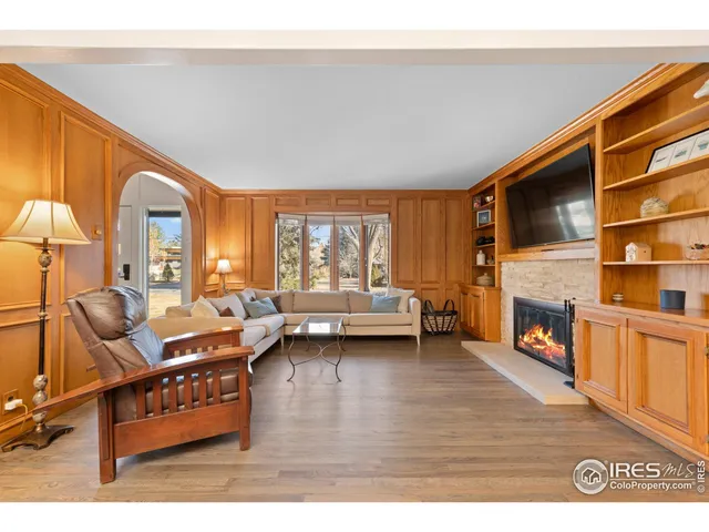 a dining room with furniture and a floor to ceiling window