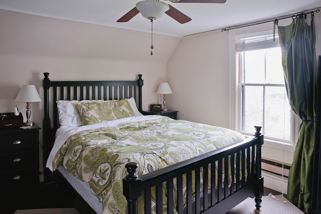 9-11 Campbell Park Somerville, MA 02144 - Photo 16 of 19 a bed sitting in a bedroom next to a window