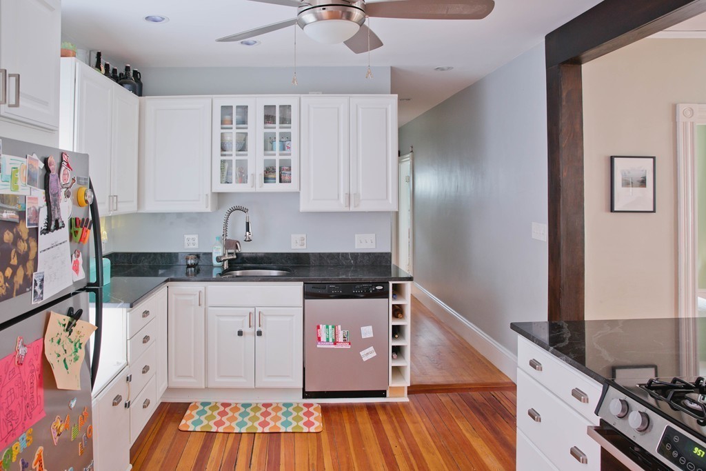 9-11 Campbell Park Somerville, MA 02144 - Photo 6 of 19 a kitchen with stainless steel appliances granite countertop a stove and a wooden cabinets