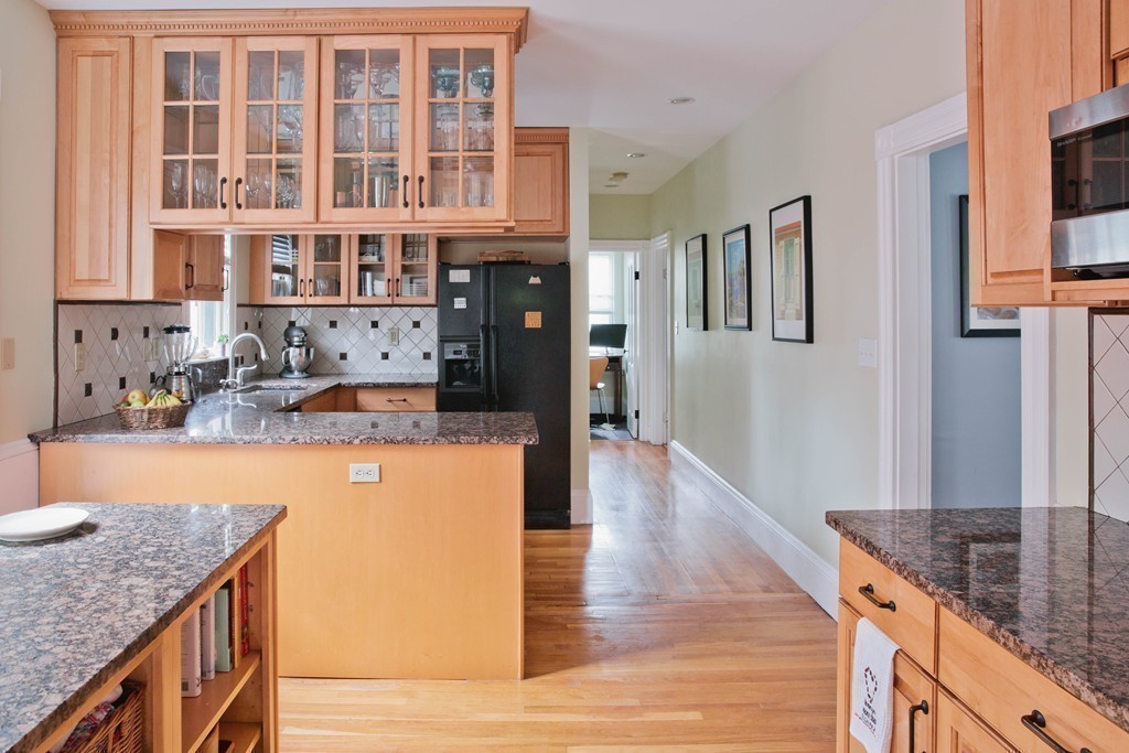 9-11 Campbell Park Somerville, MA 02144 - Photo 10 of 19 a kitchen with stainless steel appliances granite countertop a refrigerator a stove and a wooden floors