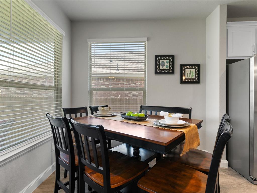 270 Lunayena Road Rhome, TX 76078 - Photo 19 of 37 The dining area offers a welcoming space for everyday meals and special gatherings, with an open flow to the kitchen and living room that creates a functional layout for entertaining and daily living.