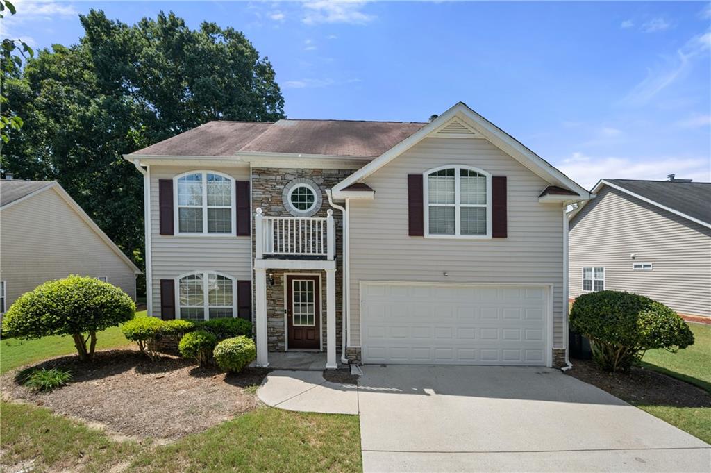 2066 Ridgestone Landing Southwest Marietta, GA 30008 - Photo 1 of 1 a front view of a house with garden