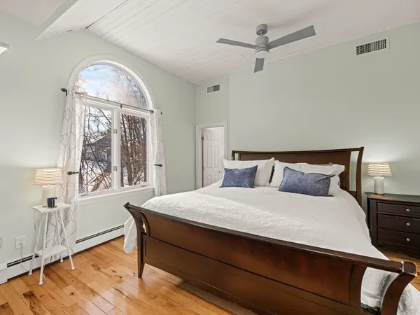 a bedroom with a bed window and a table