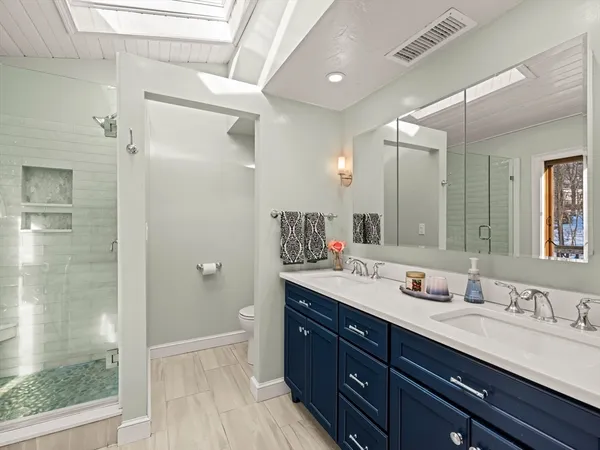 a bathroom with a granite countertop sink mirror and double