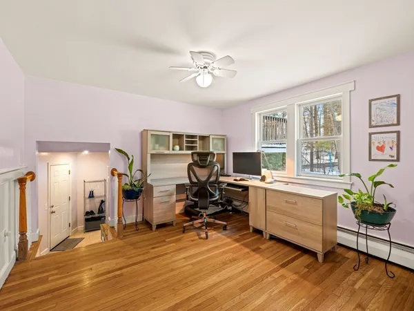 a view of a workspace with furniture and a window