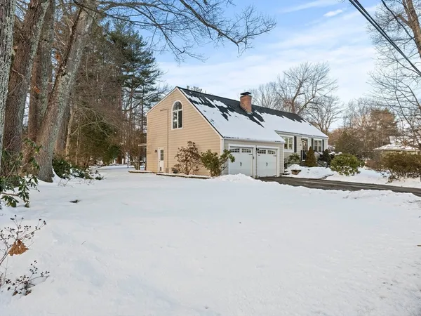 a view of a house with snow on the road