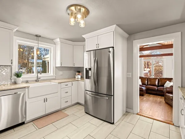 a kitchen with white cabinets and stainless steel appliances