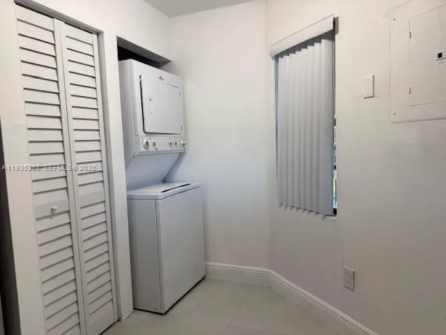 an empty room with a ceiling fan and a window