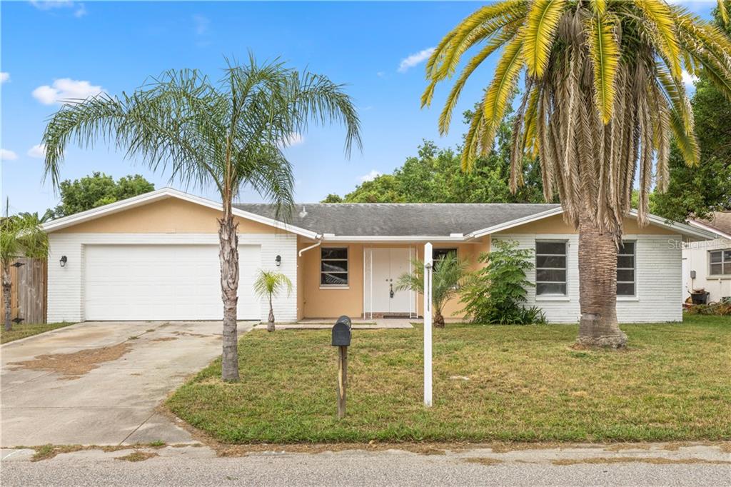10411 Oleander Drive Port Richey, FL 34668 - Photo 1 of 1 a front view of house with yard