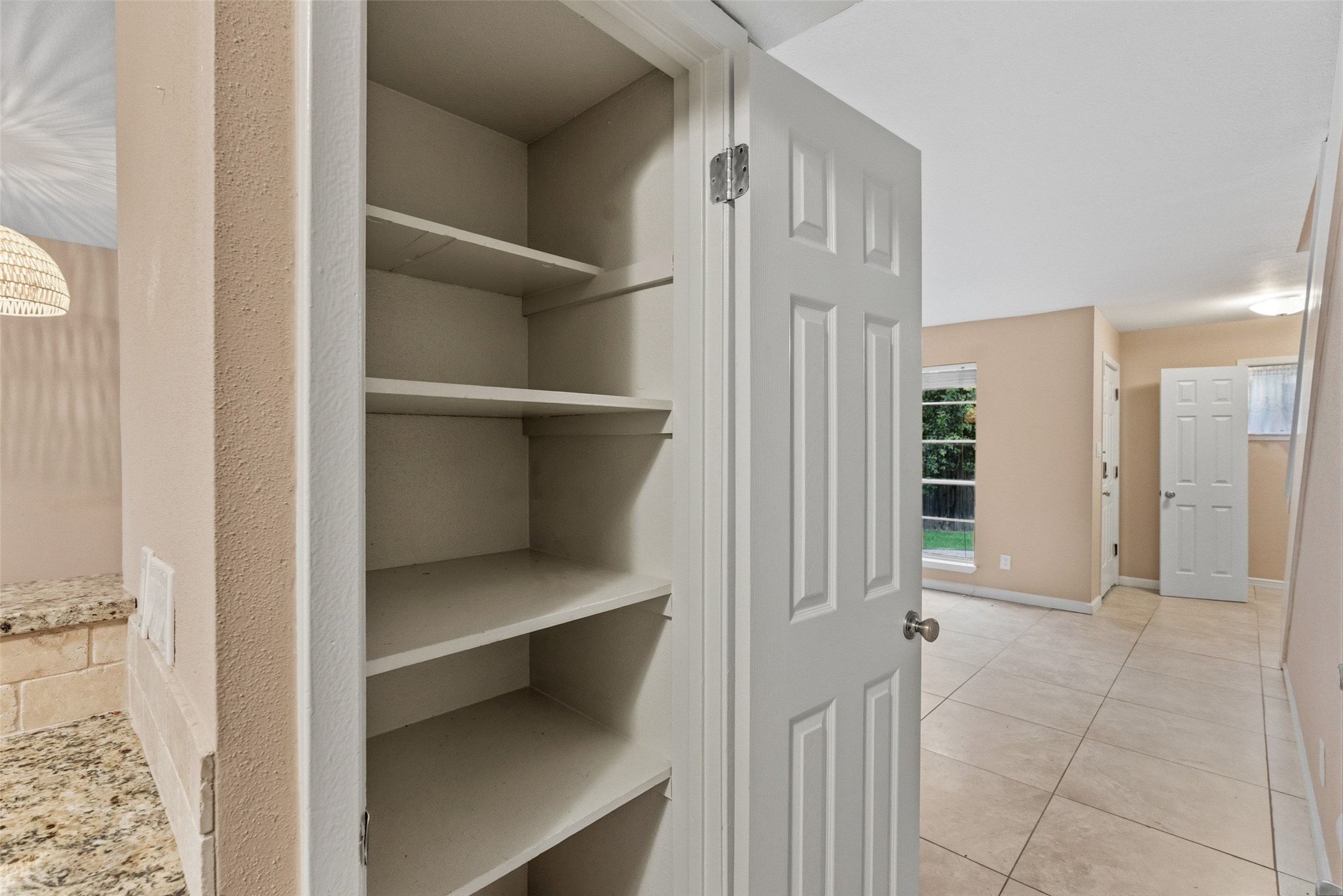 702 Castle Ridge Road, Unit C Austin, TX 78746 - Photo 33 of 36 This updated two-story residence offers approximately 1,144 square feet with 2 bedrooms, 1.5 bathrooms, and an open floor plan filled with natural light. Features include vinyl and tile flooring throughout with no carpet, granite countertops, and a walk-in shower. The main level features a comfortable living area that flows into the dining space and kitchen, creating an ideal setting for daily living and entertaining.