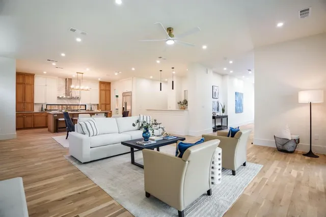 a living room with furniture and kitchen view