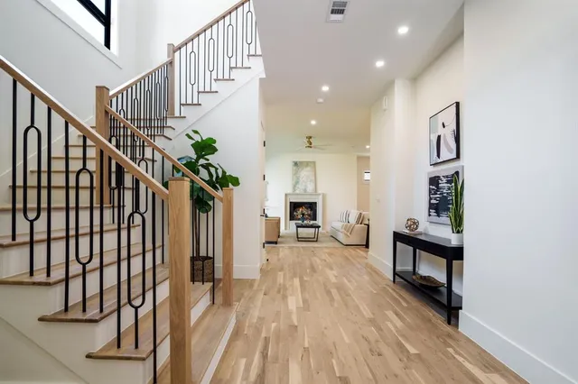 a view of entryway and hall with wooden floor