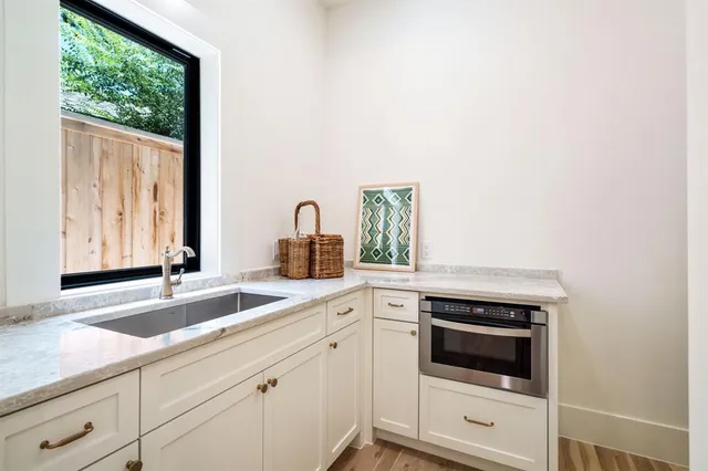 a kitchen with stainless steel appliances granite countertop a sink and cabinets